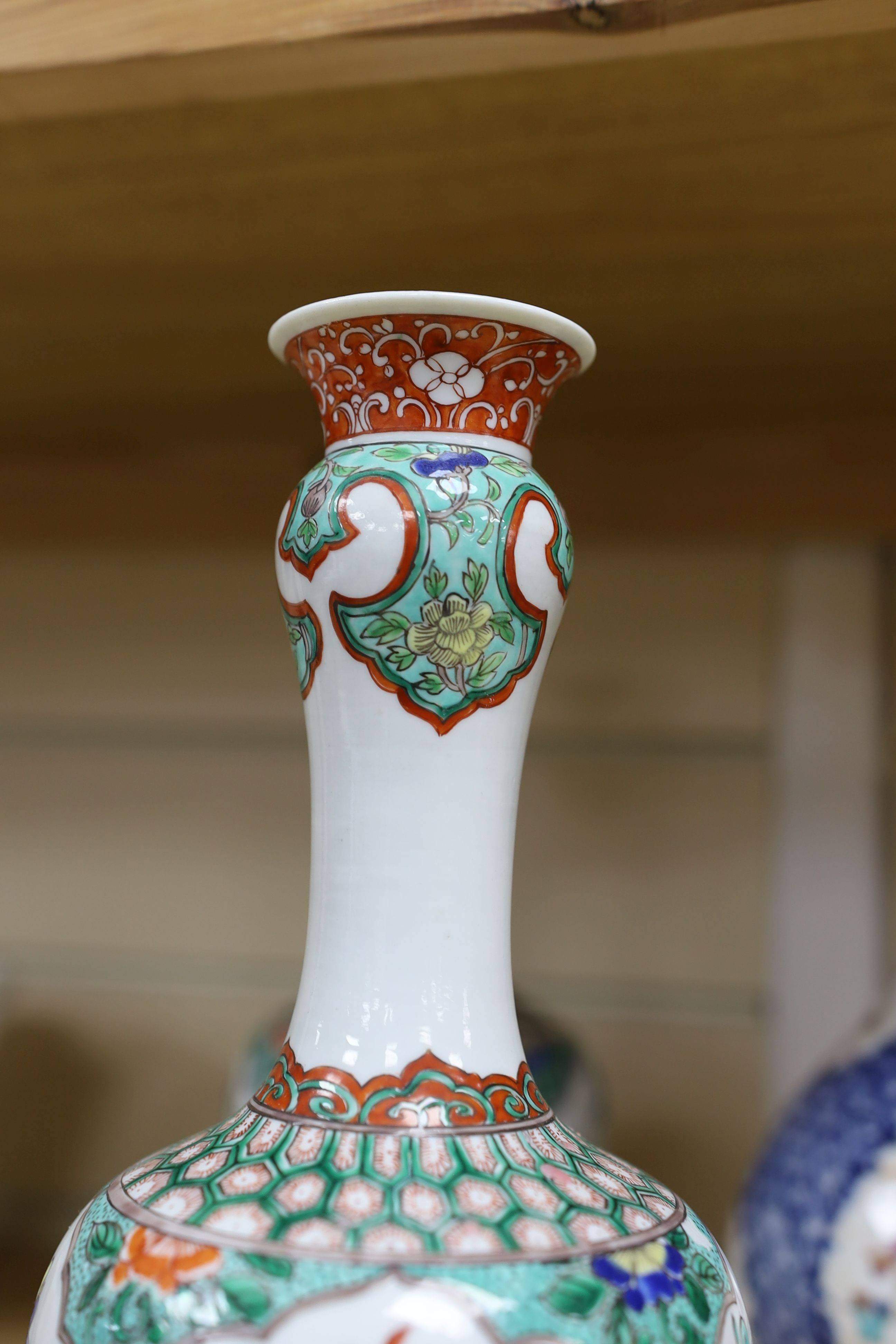 A pair Samson of Paris vases in the Chinese famille verte style and a Chinese Qianlong famille rose garlic neck vase with blue panelling motif, tallest 26cm